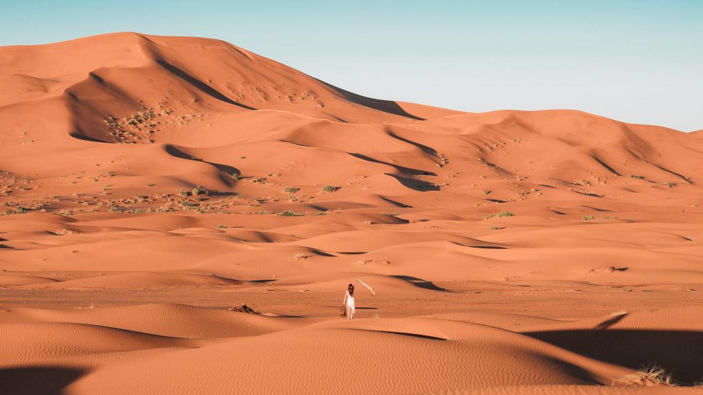 person-in-white-shirt-walking-on-desert-4253829-1024×683